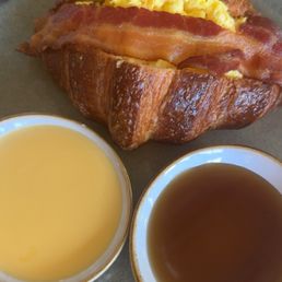 Bacon & egg croissant. Comes with maple syrup and a cheese dip Bacon & egg croissant. Comes with maple syrup and a cheese dip