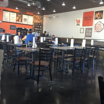 Cowboy Chicken - Owner sitting looking at blue prints of his next site - Chicken Shop Near Me - Irving, Texas