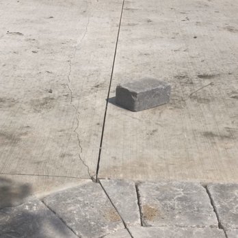 Roca Builders - 1 wk after driveway poured, this crack line to left of saw line went clear across driveway, builder refuses to fix; poor workmanship. - Home Developers Near Me Roca Builders - 1 wk after driveway poured, this crack line to left of saw line went clear across driveway, builder refuses to fix; poor workmanship. - Home Developers Near Me