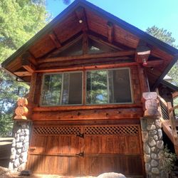 A1 Exterior - Blasted and restained cedar log siding.