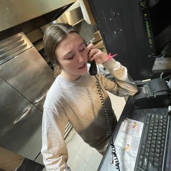 Bambino's Pizza - a woman on the phone - Italian Near Me - Springfield, Georgia