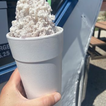 SnOGo - a hand holding a cup of ice cream - Shaved Ice Near Me