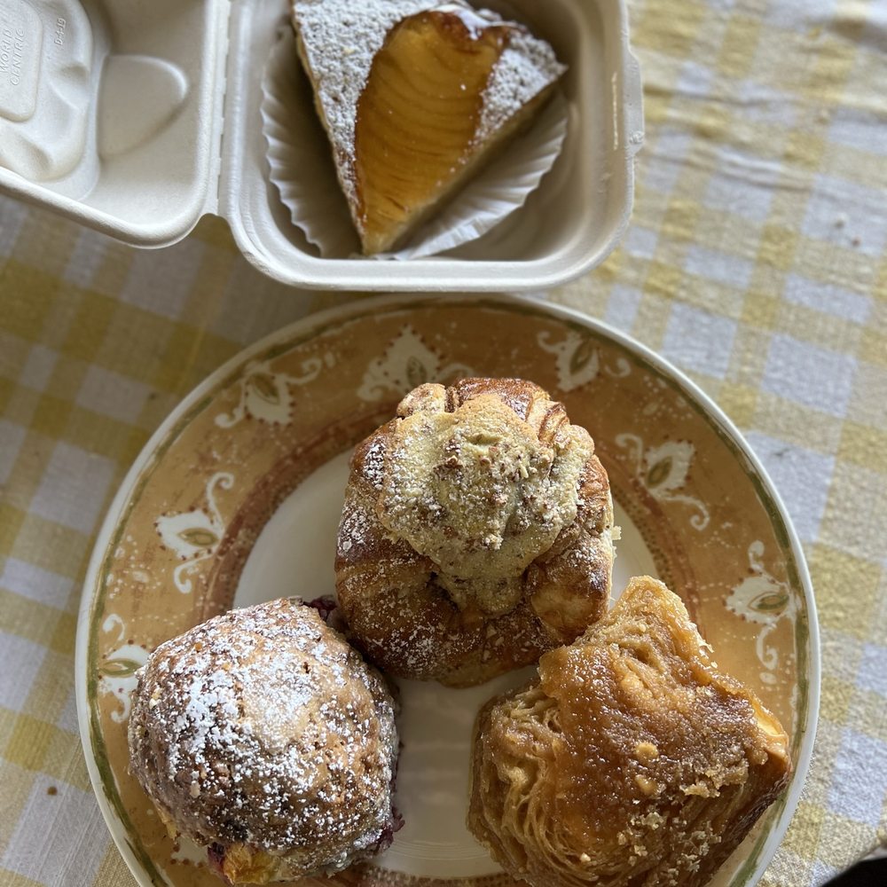 La Provence - Pear Tart (top), Mango Blueberry Scone (left), Almond Croissant (middle) and Sticky Bun (right) - French Near Me - Kula, Hawaii La Provence - Pear Tart (top), Mango Blueberry Scone (left), Almond Croissant (middle) and Sticky Bun (right) - French Near Me - Kula, Hawaii