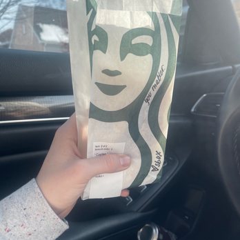 Starbucks - a person holding a starbucks bag in a car - Coffee & Tea Near Me - Cary, Illinois Starbucks - a person holding a starbucks bag in a car - Coffee & Tea Near Me - Cary, Illinois