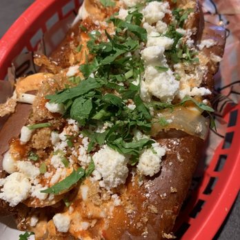 Dirt Dog - Tapatio Dog (bacon, serrano spread, red sauce, grilled veggies, Tapatio aioli, chicharrones, queso fresco, cilantro); IG: @katzlundell - Hot Dogs Near Me - Long Beach, California