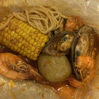 Cap't Loui - Shrimps(head on)&mussel with side of corn and potato(and a bit noodle from my friend) with capt loui seasoning!!!! - Cajun/Creole Near Me - Duluth, Georgia