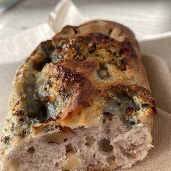 Louise - a closeup of a piece of bread on a napkin - Bakeries Near Me - Montreal, Quebec