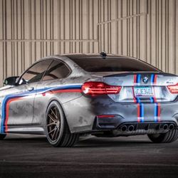 Fast Lane Window Tinting - BMW M4 with custom satin wrap, stripes, and ceramic tint.