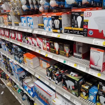 Welden Hardware - The image shows a retail store shelf stocked with LED bulbs, light fixtures, and lighting accessories, organized by brand and type. - Hardware Stores Near Me - Simsbury, Connecticut
