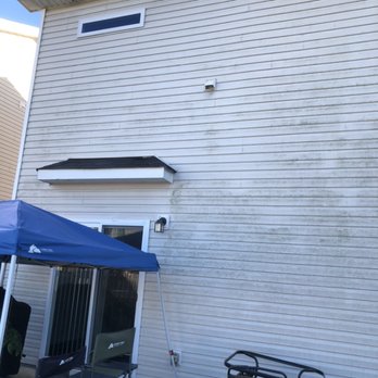 Top Shelf Trimmers - a white house with a blue awning - Landscaping Near Me Top Shelf Trimmers - a white house with a blue awning - Landscaping Near Me