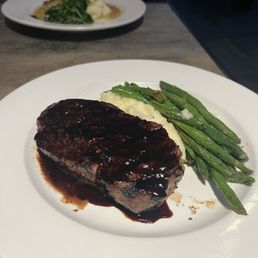 Steak and mashed potatoes with green beans.