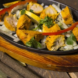 Indian Lounge Restaurant - Grilled chicken marinated overnight and served on sizzler
