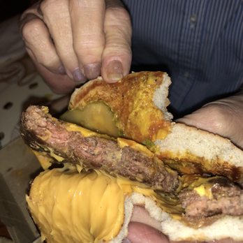 McDonald's - a man holding a hamburger and fries - Fast Food Near Me - Charleston, Tennessee