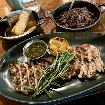 Carnicero Steakhouse - Grilled chicken breast with a side of fried yuca and arroz moro. - Steakhouses Near Me - Miami, Florida