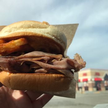 Arby's - a person holding a sandwich in their hand - Fast Food Near Me - Aurora, Nebraska Arby's - a person holding a sandwich in their hand - Fast Food Near Me - Aurora, Nebraska