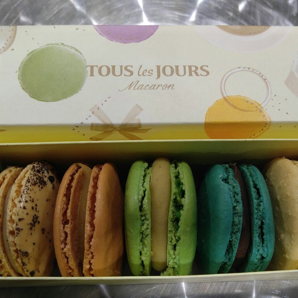 Tous Les Jours - macarons left to right: oreo, nutella, salted caramel, pistacio, mint, coconut - Bakeries Near Me - Edison, New Jersey Tous Les Jours - macarons left to right: oreo, nutella, salted caramel, pistacio, mint, coconut - Bakeries Near Me - Edison, New Jersey