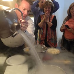 Steve is carefully pouring liquid nitrogen to use for cold fondue. What great fun!