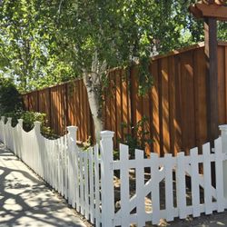 Saul's Pressure Washing - After we paint picket fence and stain redwood fence with cedar natural color.
