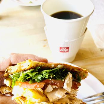 Cinnamon Tree Cafe - a hand holding a half eaten sandwich - Creperies Near Me - Port Orange, Florida