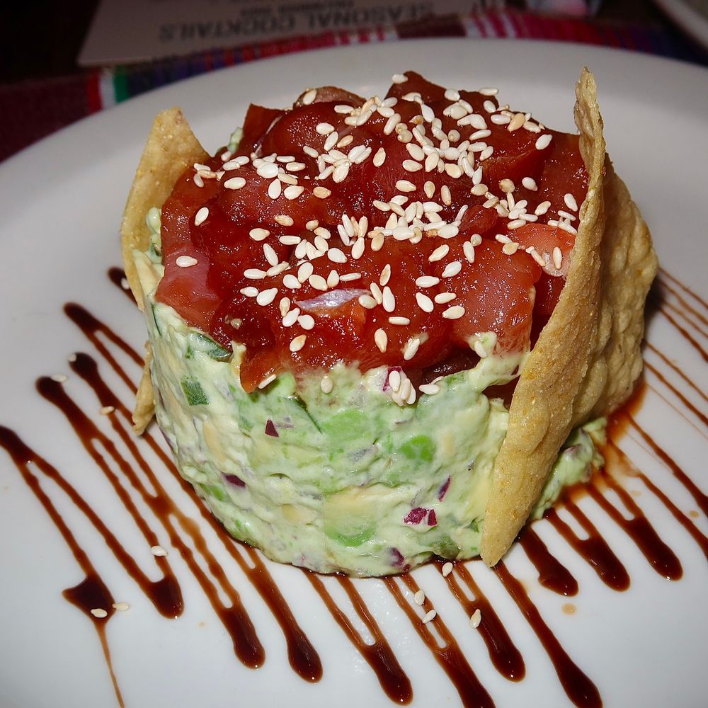 La Doña Mezcaleria - The Tartar De Atun was made with Ahi Tuna marinated in soy sauce, served on a bed of avocado, onion, tomato, topped with a balsamic drizzle. - Mexican Near Me - Denver, Colorado La Doña Mezcaleria - The Tartar De Atun was made with Ahi Tuna marinated in soy sauce, served on a bed of avocado, onion, tomato, topped with a balsamic drizzle. - Mexican Near Me - Denver, Colorado