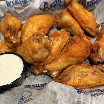 Rusty's Raw Bar & Grill - Bone in wings lightly tossed with hot buffalo sauce, side of ranch - Bars Near Me - Fort Myers, Florida