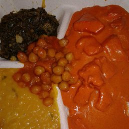 Vibrant butter chicken with side of lentil and spinach. Sample of beans in middle. Vibrant butter chicken with side of lentil and spinach. Sample of beans in middle.