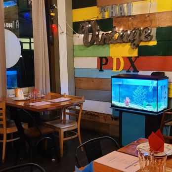 Thai Vintage PDX - a dining room with a television - Thai Near Me - Portland, Oregon
