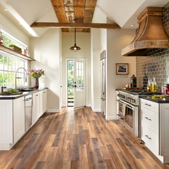 Abbey Design Center - a kitchen with white cabinets and wood floors - Carpeting Near Me - Osseo, Minnesota Abbey Design Center - a kitchen with white cabinets and wood floors - Carpeting Near Me - Osseo, Minnesota