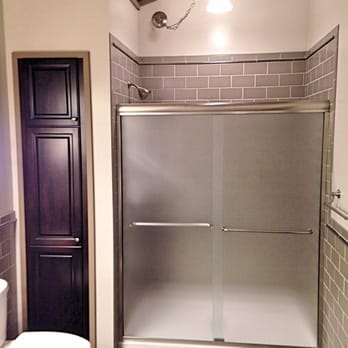 Quality Design Renovations - a bathroom with a shower and toilet - General Contractors Near Me