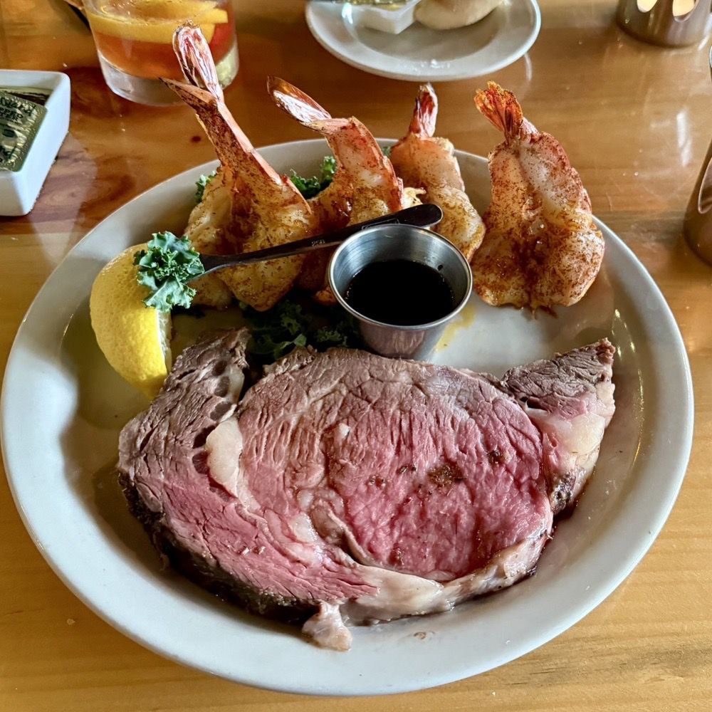 Ishnala - Prime Rib and 4 Broiled Prawns - served with Au Jus, Creamy Horseradish and Melted Butter - Steakhouses Near Me - Wisconsin Dells, Wisconsin Ishnala - Prime Rib and 4 Broiled Prawns - served with Au Jus, Creamy Horseradish and Melted Butter - Steakhouses Near Me - Wisconsin Dells, Wisconsin