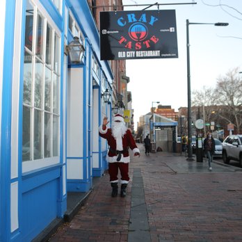 CrayTaste - a man dressed as santa claus walking down a sidewalk - Soul Food Near Me - Philadelphia, Pennsylvania