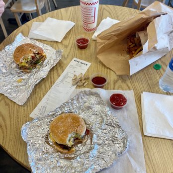 Five Guys - a table with two burgers and fries - Burgers Near Me - Easley, South Carolina Five Guys - a table with two burgers and fries - Burgers Near Me - Easley, South Carolina