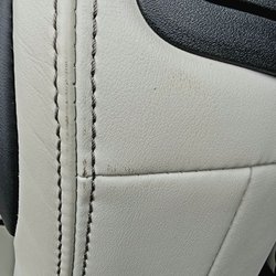 Qualtech Automotive - Grease from the mechanic hands touching the back of the driver's seat