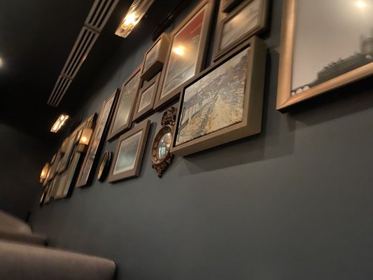 Photo of Bambara - Cambridge - Cambridge, MA, US. a row of framed photographs on a wall