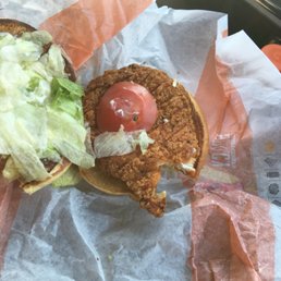 a chicken sandwich with lettuce and tomato a chicken sandwich with lettuce and tomato
