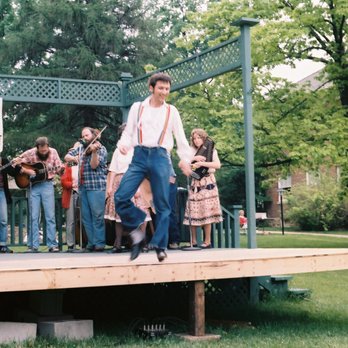 Campbell Center For Historic Preservation Studies - Clogger performing a buck dance. Members of Stone Soup can be seen playing bones, banjo, guitar, fiddle, and zither. - Education Near Me Campbell Center For Historic Preservation Studies - Clogger performing a buck dance. Members of Stone Soup can be seen playing bones, banjo, guitar, fiddle, and zither. - Education Near Me