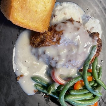 Montana's - a plate of meat with gravy and green beans - Steakhouses Near Me - Winnipeg, Manitoba Montana's - a plate of meat with gravy and green beans - Steakhouses Near Me - Winnipeg, Manitoba