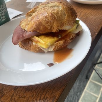 Lucabe Coffee Co - Croissant with Mariah ham, garden egg, hot honey and havarti cheese. - Cafes Near Me - Columbus, Indiana Lucabe Coffee Co - Croissant with Mariah ham, garden egg, hot honey and havarti cheese. - Cafes Near Me - Columbus, Indiana