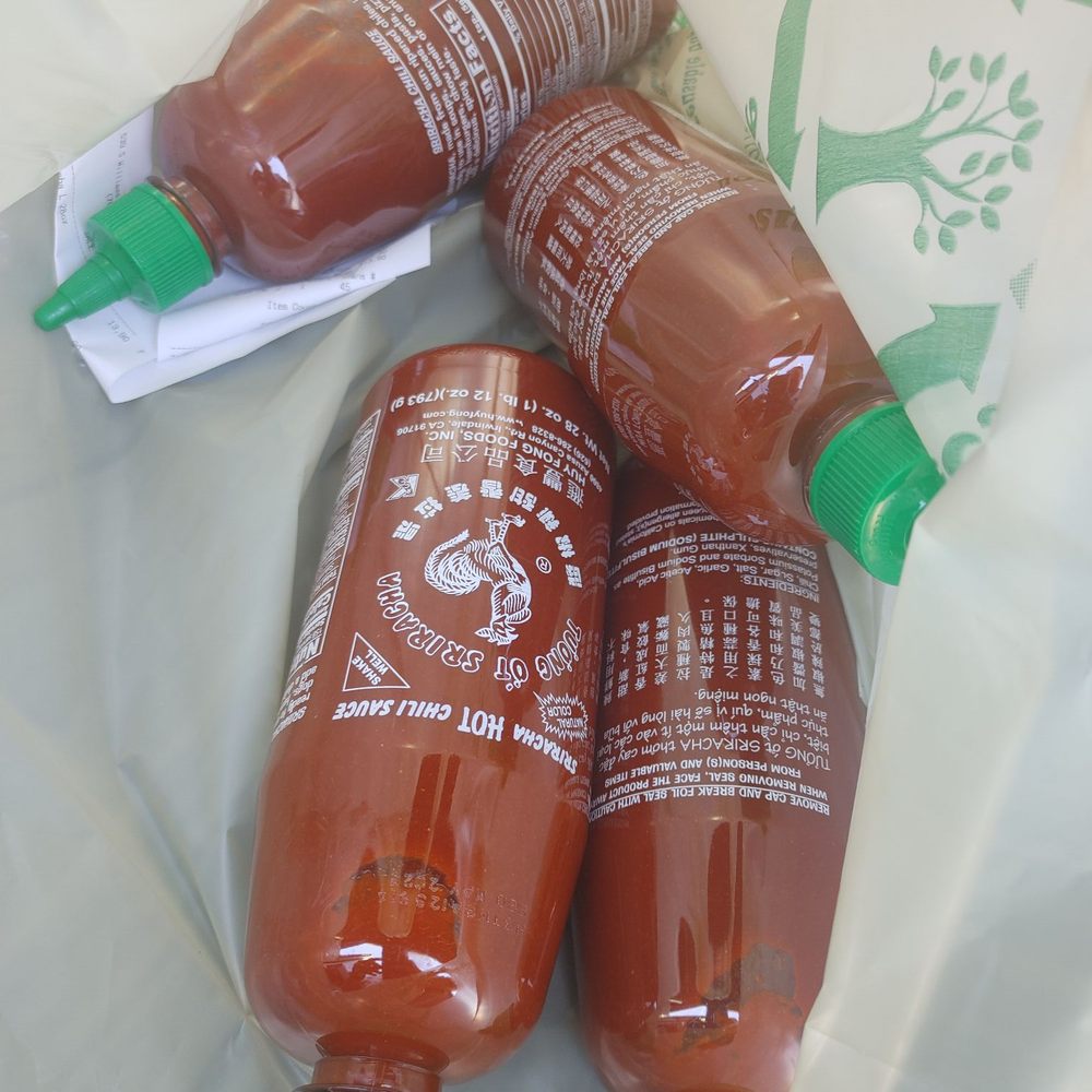 Aj Market - three bottles of hot sauce in a bag - International Grocery Near Me - Palm Springs, California