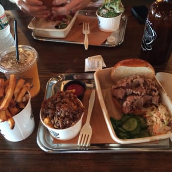 Mighty Quinn's Barbeque - Brisket sandwhich, frites, sweet potatoes, cole slaw, ice tea and some pickles that were really cucumbers... Still off the hook! - Barbeque Near Me - Clifton, New Jersey
