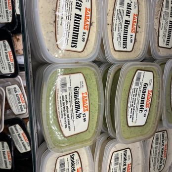 Zabar's - Za'atar hummus!!!! - Plastic containers of hummus, guacamole, and whitefish dip are displayed on store shelves at Zabar's, with labels showing flavors and prices. - Bakeries Near Me - New York, New York
