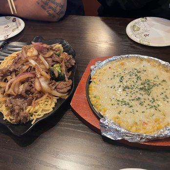 Luv Dduk - Garlic bulgogi noodle in black dish and corn cheese in red dish - Korean Near Me - Cerritos, California