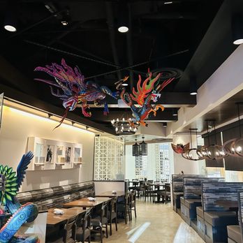 Zocalito Latin Bistro - Inside seating with some hanging alebrijes - Latin American Near Me - Denver, Colorado Zocalito Latin Bistro - Inside seating with some hanging alebrijes - Latin American Near Me - Denver, Colorado
