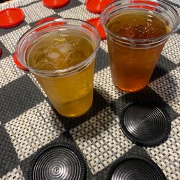 two cups of beer on a checkered table two cups of beer on a checkered table