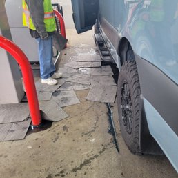 Attendant try to help by providing some padding material from his own truck to cover the diesel on the floor Attendant try to help by providing some padding material from his own truck to cover the diesel on the floor