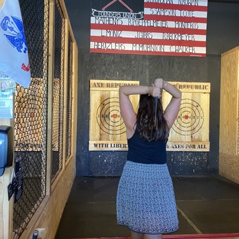 Axe Republic - a woman standing in front of a target - Axe Throwing Near Me - Williamsburg, Virginia Axe Republic - a woman standing in front of a target - Axe Throwing Near Me - Williamsburg, Virginia