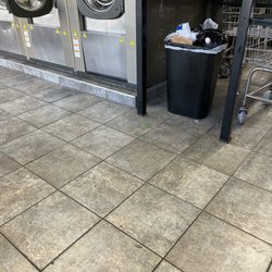 Federal Hill Laundromat - Dirty floor and trash overflowing.