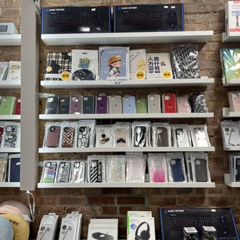 Square Plus Wireless - iphone cases - Store shelves hold various phone cases, electronic accessories, and gaming peripherals, with some boxed items and colorful designs. - Mobile Phone Repair Near Me - Brooklyn, New York