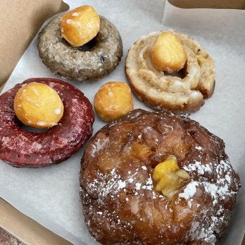 Sweet Apple Donut & Coffee - Red velvet and blueberry in the back left. The bottom right was apple based. All light and crunchy on the outside! - Donuts Near Me - Alpharetta, Georgia Sweet Apple Donut & Coffee - Red velvet and blueberry in the back left. The bottom right was apple based. All light and crunchy on the outside! - Donuts Near Me - Alpharetta, Georgia