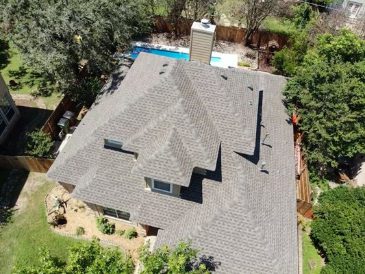 GAF Timberline HDZ Weathered Wood Re-Roof — Before & After - Barnes N' Roofs completed a roof tear-off and replacement in New Braunfels, Texas, using GAF Timberline HDZ architectural shingles in Weathered Wood. The project included underlayment, ridge ventilation and flashing work. Nine before-and-after photographs show the original roof and the completed shingle installation. This project illustrates the roofing materials and work included in this replacement; applicable warranty terms depend on the installed system and project documentation. GAF Timberline HDZ Weathered Wood Re-Roof — Before & After - Barnes N' Roofs completed a roof tear-off and replacement in New Braunfels, Texas, using GAF Timberline HDZ architectural shingles in Weathered Wood. The project included underlayment, ridge ventilation and flashing work. Nine before-and-after photographs show the original roof and the completed shingle installation. This project illustrates the roofing materials and work included in this replacement; applicable warranty terms depend on the installed system and project documentation.